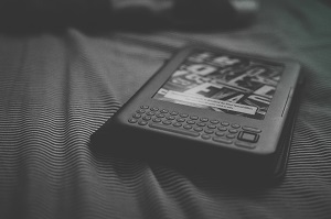 A black and white photo of a first generation Kindle